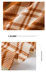 Detail van een zachte oranje en witte geruite sjaal met franje en mooie kwastjes.
