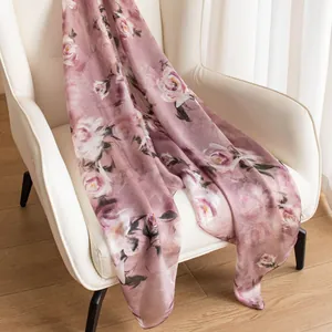 Elegant mulberry silk floral scarf shawl draped on white armchair for beach vacation