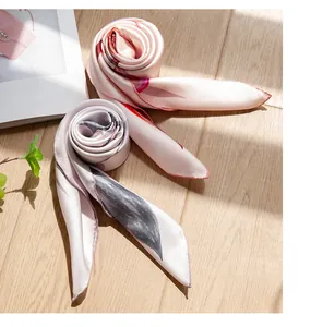Close-up view of elegant silk scarves with delicate oil painting prints and smooth texture