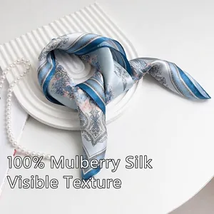 Elegant 53cm mulberry silk square scarf with intricate blue paisley patterns.