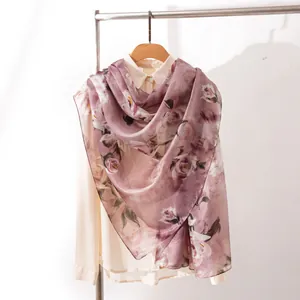 Elegant mauve floral silk scarf draped on a shirt for a stylish bohemian look