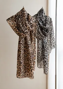 Detailed macro view of lightweight mulberry silk long scarves with leopard prints