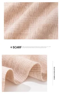 Close-up detail of the soft texture and pink plaid pattern of a 100% wool scarf.