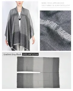 Detailed view of grey gradient poncho showing fabric texture and 148x117cm size dimensions.