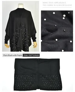 Detailed view of elegant black faux cashmere cape shawl decorated with delicate pearls