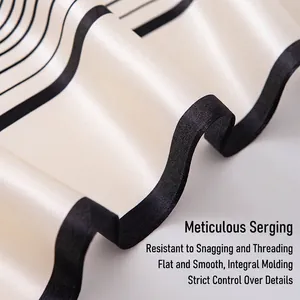 Detailed view of luxury 100% mulberry silk scarf with elegant black and cream pattern