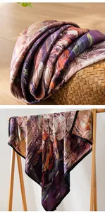 Detailed macro view of an artistic floral print mulberry silk scarf on a wooden rack