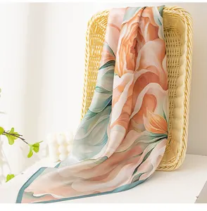 Detailed view of the large peony floral print on a luxurious mulberry silk square scarf