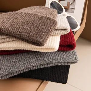 Selection of thick knitted cow cashmere beanies in various warm autumn colors for women
