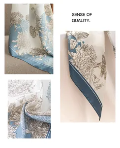 Close-up detail of elegant floral pattern on a lightweight silk-like square scarf.