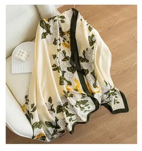 Close-up of elegant cream silk scarf with white roses and golden chain print