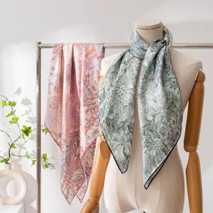 Detail of elegant mulberry silk floral square scarf draped on a mannequin for styling