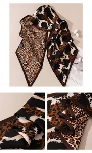Close-up detail of double-sided silk-wool scarf with leopard and cow print patterns