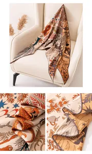 Macro view showing the intricate mythological pattern and fine texture of silk wool scarf.