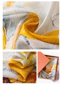 Macro detail of luxury mulberry silk scarf with yellow floral print and gift box packaging