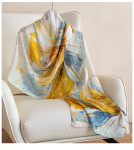 A detailed close-up of a premium mulberry silk scarf draped elegantly on a white chair