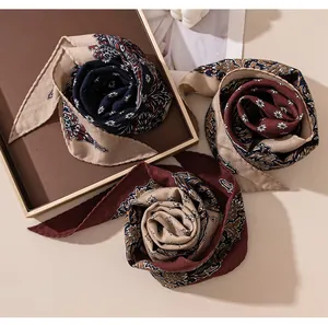 Detailed view of three vintage luxury silk wool scarves rolled into decorative rose shapes