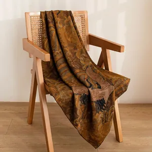 Elegant Xiangyun silk shawl with traditional Chinese crane pattern on wooden chair