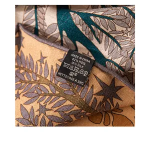 Detailed view of the fabric care label on a luxury wool and silk blend triangle shawl