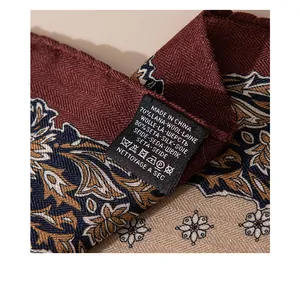 Close-up of silk and wool scarf care label showing material composition and texture