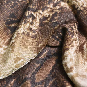 Detailed close-up of a printed imitation cashmere shawl featuring a brown snake pattern