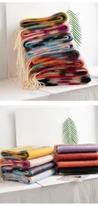 Detailed view of stacked colorful mohair rainbow plaid scarves with soft tassels