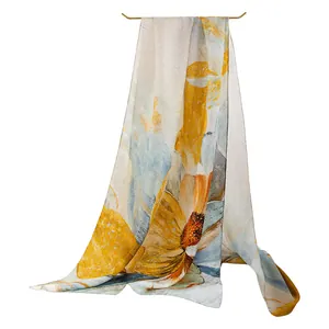 Elegant large mulberry silk floral scarf with yellow and blue artistic print for women.