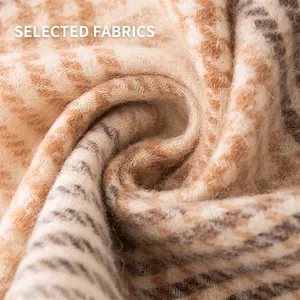 Detailed macro view of soft houndstooth wool scarf fabric texture for winter warmth