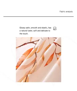 Close-up of glossy satin silk scarf fabric with elegant orange leaf pattern