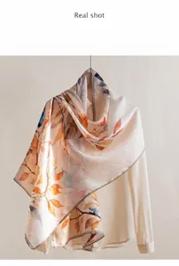 Detailed view of mulberry silk shawl with autumn leaf print on light fabric