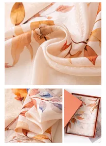 Close-up of luxury mulberry silk scarf with an autumn leaf pattern in a gift box