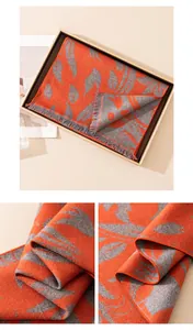 Detailed view of orange and grey leaf pattern on a double-sided silk warm scarf