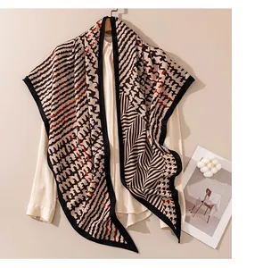 Detailed view of a vintage geometric patterned scarf draped over a white shirt.