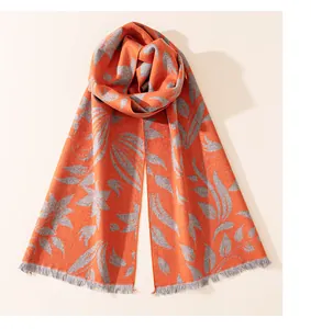 Close-up of elegant orange and grey silk scarf with frayed edge details