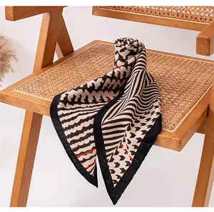 Close-up view of an elegant geometric pattern shawl draped on a vintage rattan chair