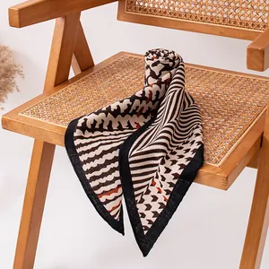 Retro geometric linear triangular scarf for women, soft shawl shown on a vintage chair