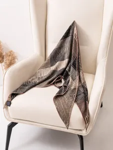 Close-up detail of the luxury striped silk and wool triangular scarf with rolled edges.