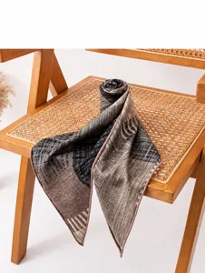 Close-up detail of a striped silk wool scarf elegantly draped on a vintage rattan chair