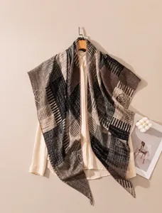 Detail of silk-wool triangle scarf with stripes and rose patterns on a hanger