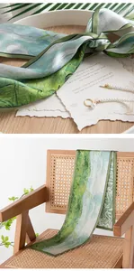 Close-up of vintage silk scarf showing green oil painting pattern and soft texture