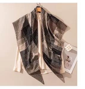 Elegant silk wool scarf with stripes and flower embroidery draped over a cream shirt