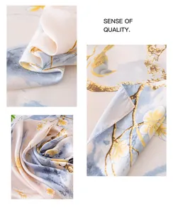 Detailed view of elegant floral silk scarf with soft pastel patterns and glossy finish