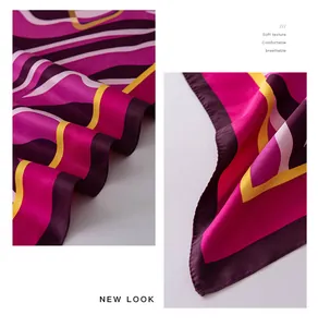 Close-up detail of vibrant printed silk square scarf showing soft twill fabric texture