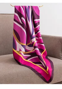 Large 90cm square scarf with pink and purple ethnic print draped over a grey sofa
