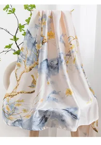 Close-up detail of elegant floral silk scarf with vintage bird and landscape pattern