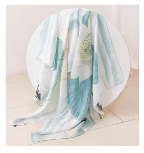 Detail view showing the delicate lotus and koi fish print on a soft silk satin shawl