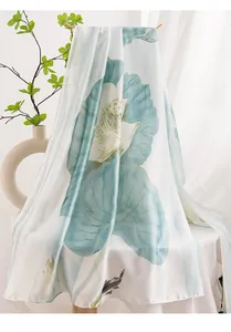 Close-up detail of high-quality silk satin scarf with elegant blue lotus and koi fish ink print