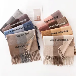 Soft cashmere-like plaid scarf with tassels in various trendy winter colors for warmth.