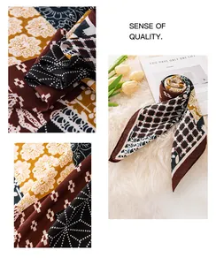 Close-up detail of a pastoral cotton-linen square scarf with chic geometric patterns