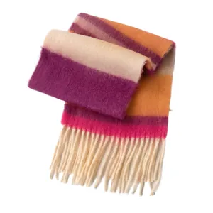 Vibrant multi-colored striped rainbow knit scarf with thick warm fringe tassels for winter